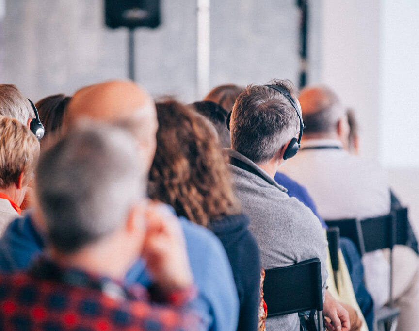 group-of-people-listening-to-presentation-with-headsets-on