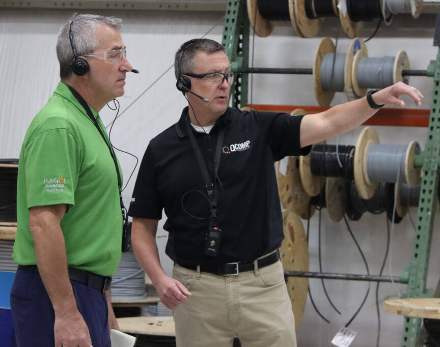 men-on-headsets-on-factory-floor